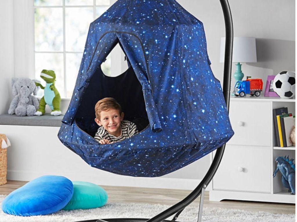 boy sitting in galaxy hangout pod in room