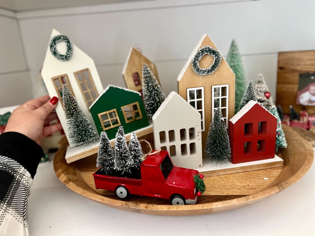 michaels christmas decor wooden cottages and red trucks on display