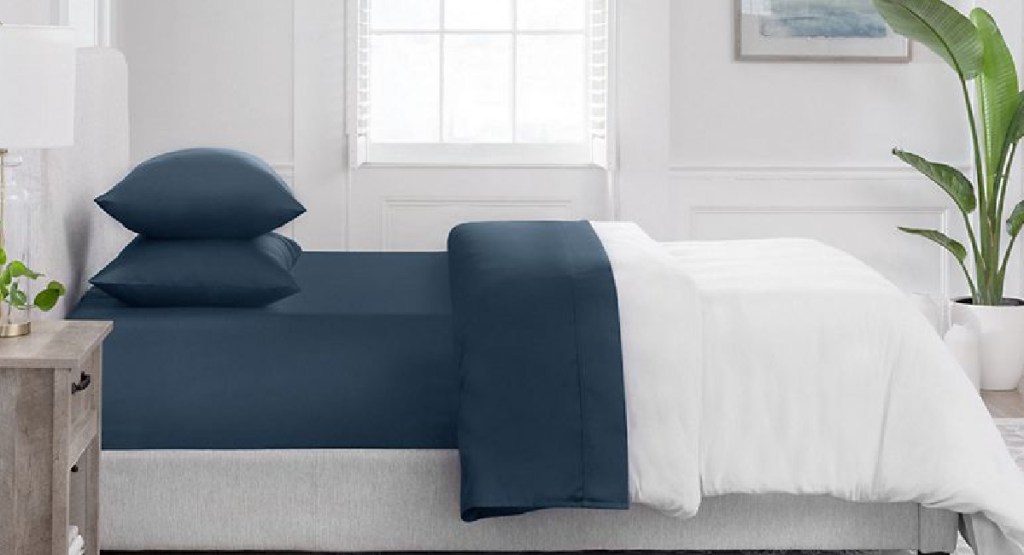 navy sams club bedsheet showcased on a bed