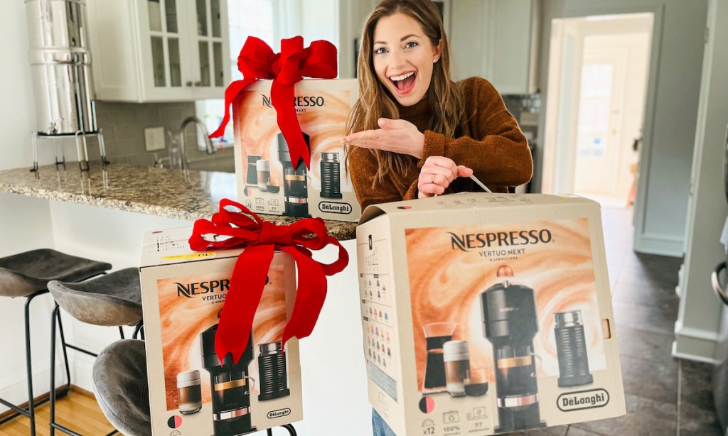 woman holding nespresso box surrounded by boxes with big red bows