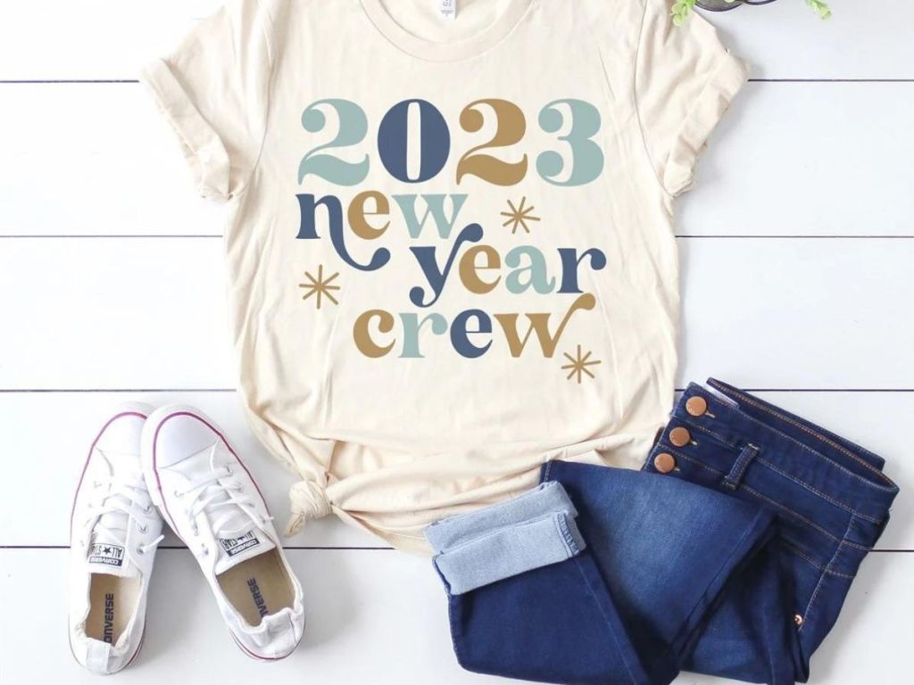 2023 new years crew tee jeans and white shoes