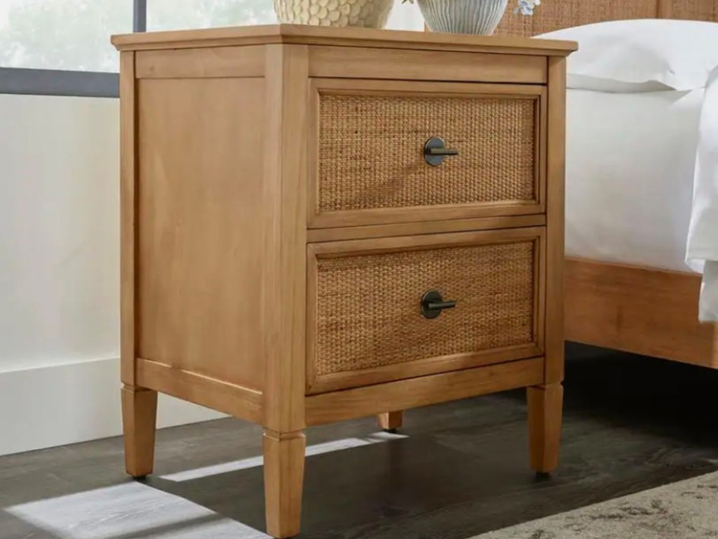 brown two drawer nightstand next to bed