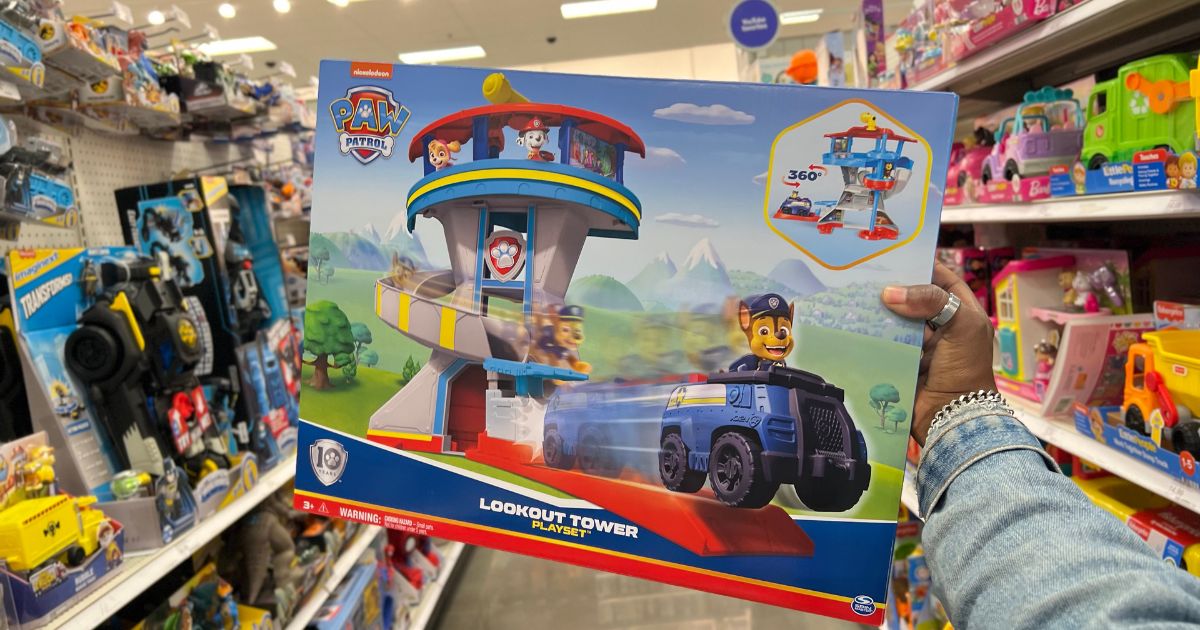 hand holding Paw Patrol Lookout Tower in toy aisle in store