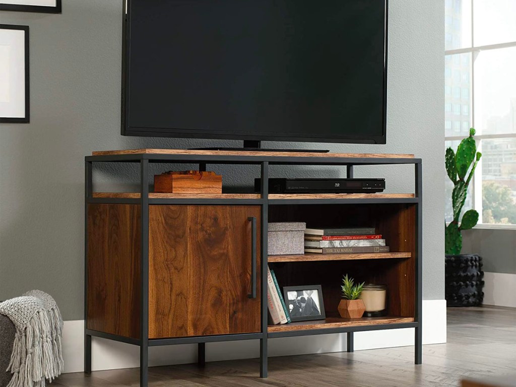 brown sauder tv stand with tv on top