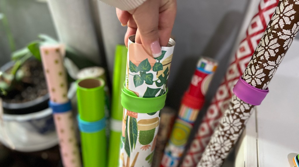 hand holding a roll of wrapping paper 