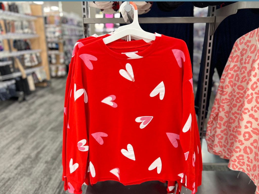 woman holding valentines pajamas in target