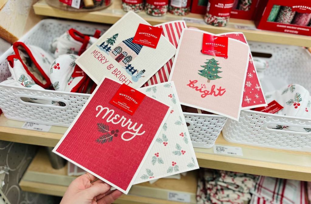 hand holding holiday theme swedish dishcloths in target store