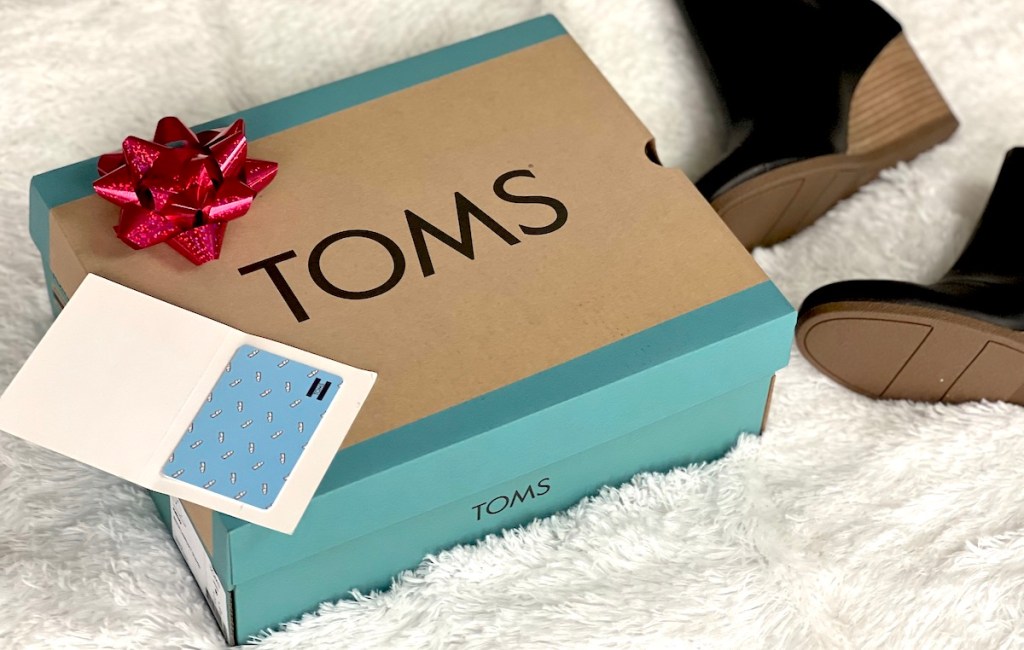 toms shoe box on white fur blanket
