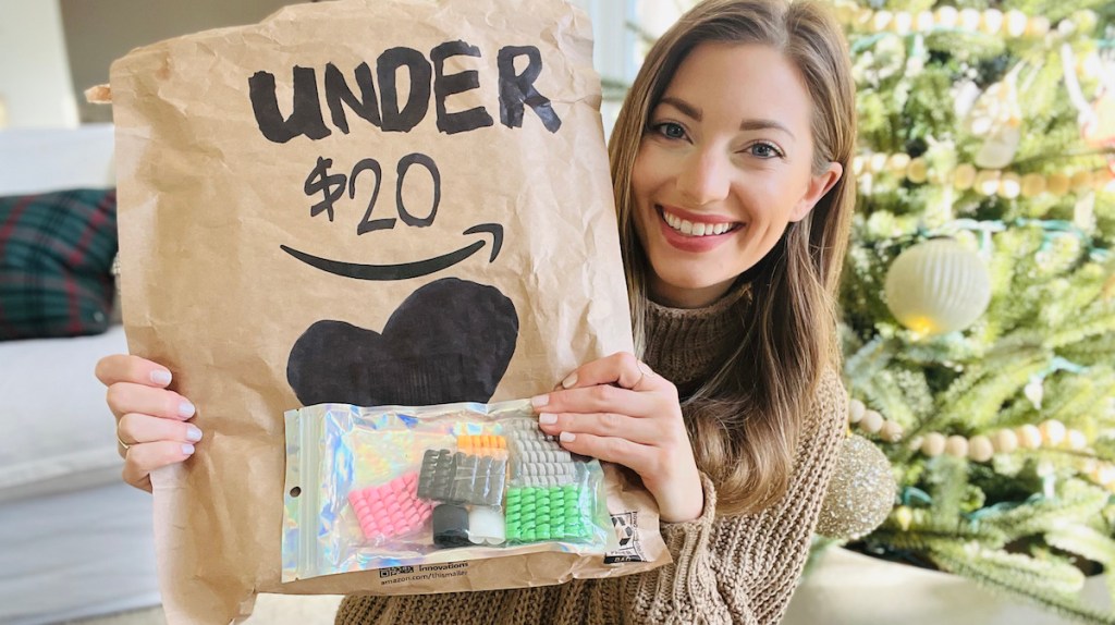 Woman holding a brown bag with gifts under $20