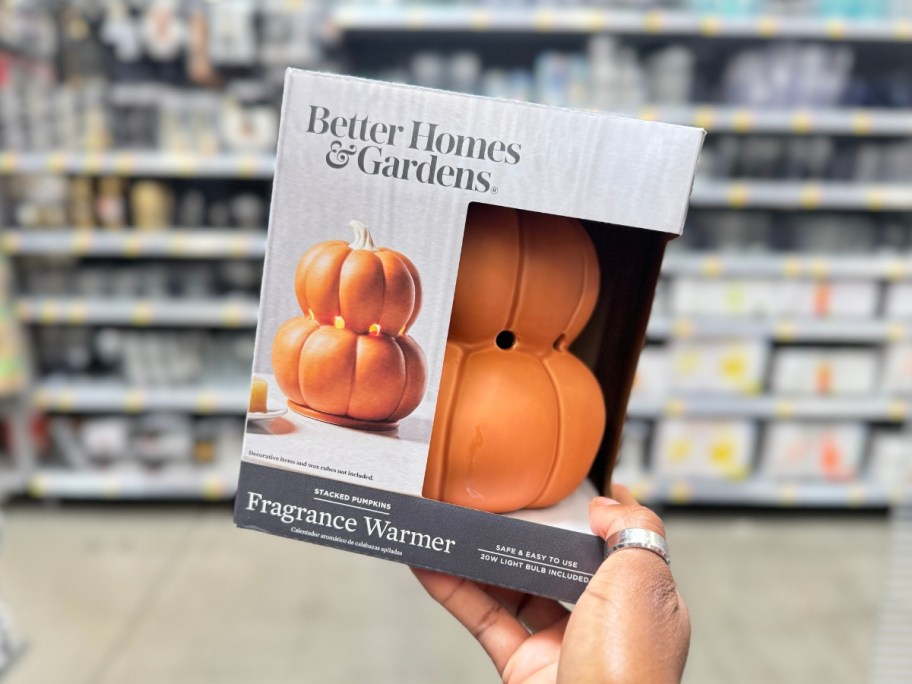 hand holding a box with a double pumpkin wax warmer in it in Walmart