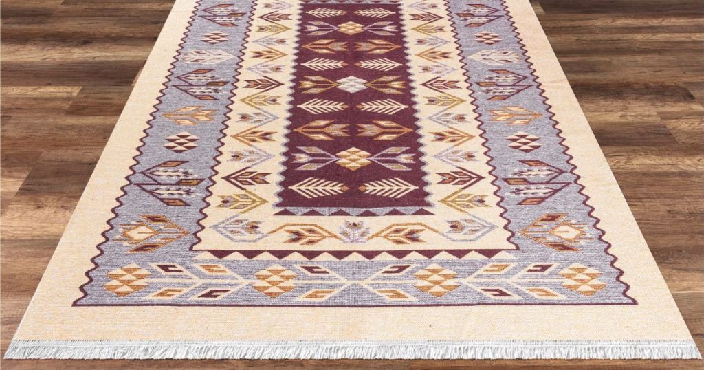 beige and colorful area rug on hardwood floor
