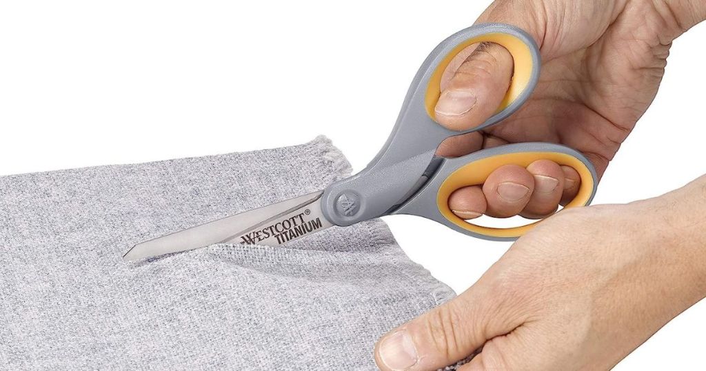 person using scissors on fabric