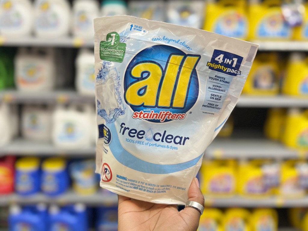 hand holding up a pack of all free clear laundry detergent pacs