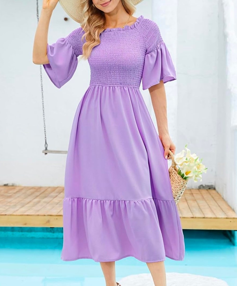 woman wearing DRESSTELLS 3/4 Sleeved Crewneck Smocked Boho Swing Dress in lavender
