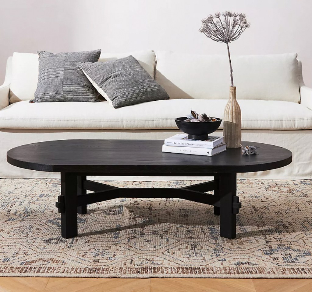 black coffee table in staged living room with decor 