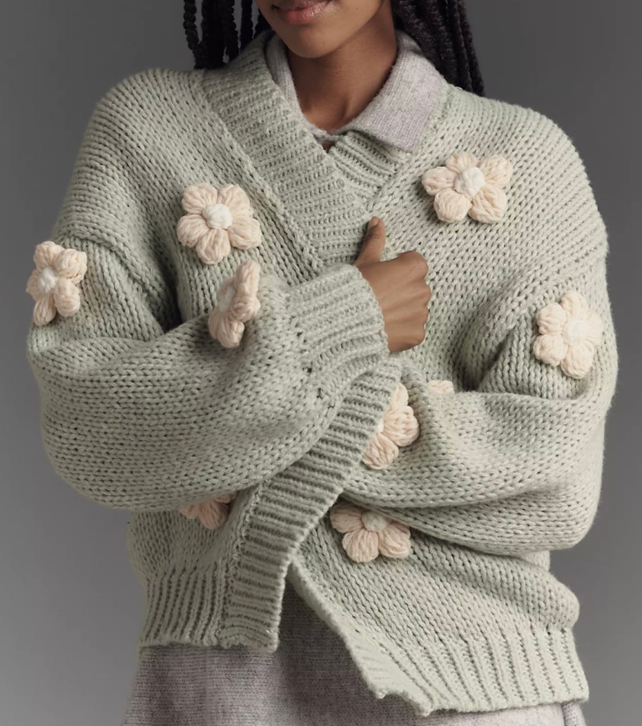 close up of woman wearing 3d flower sweater 