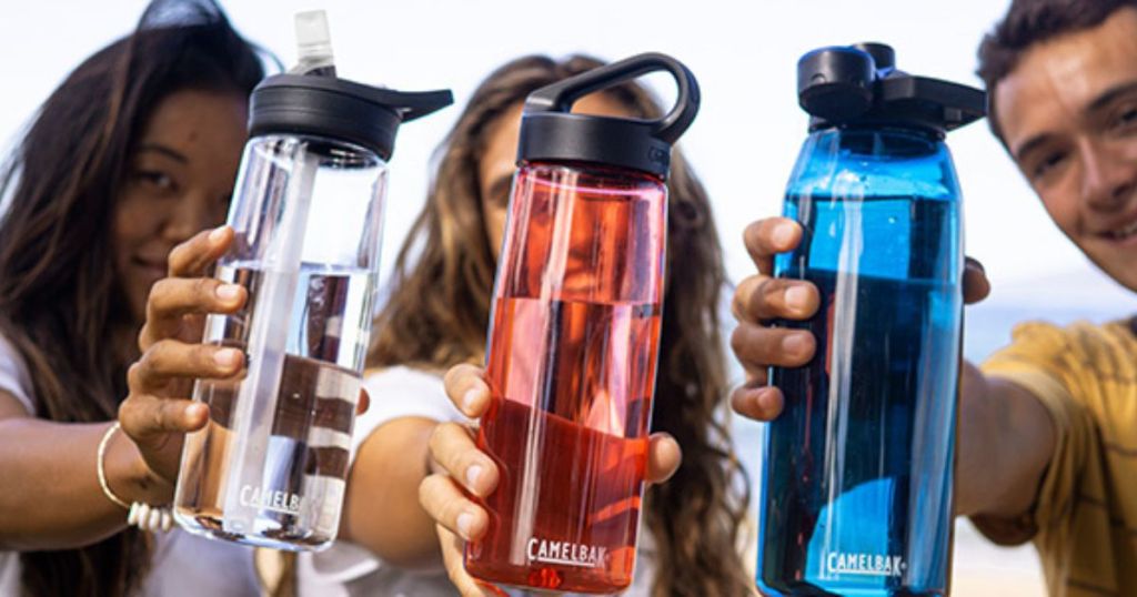 Three people holding CamelBak water bottles