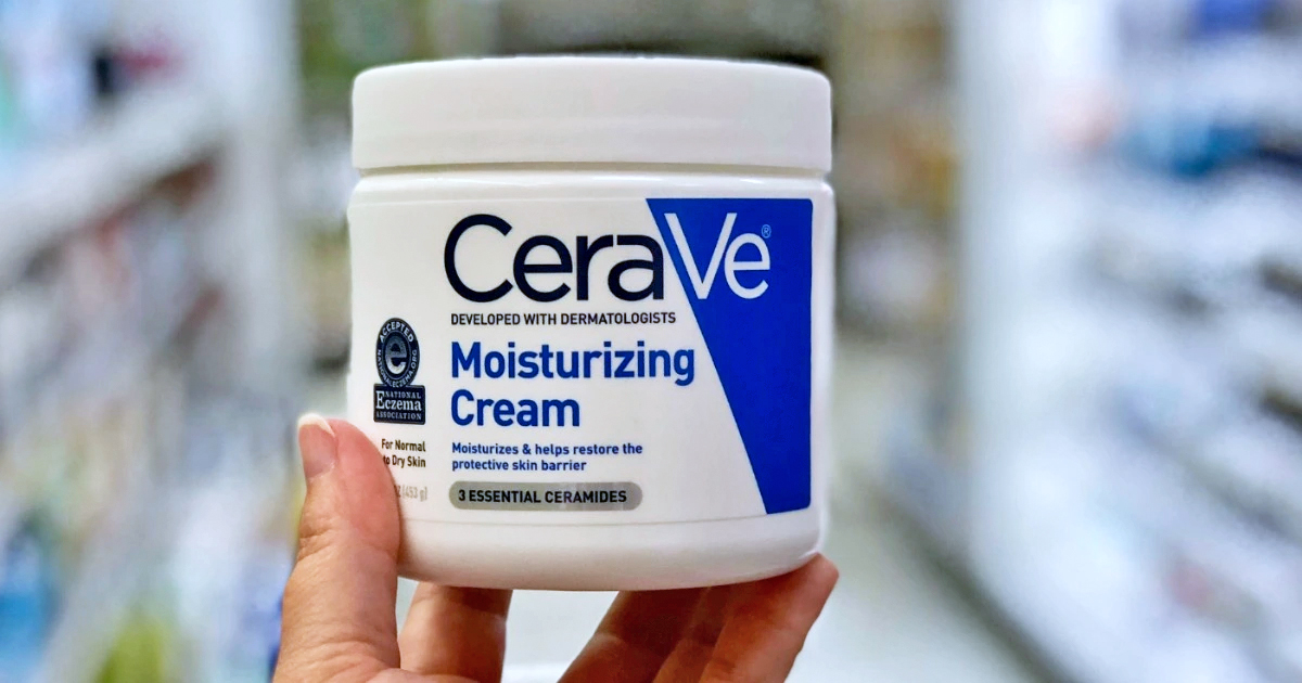 hand holding jar of CeraVe Moisturizing Cream