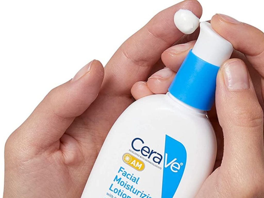 hand pumping Cerave AM Moisturizing lotion onto index finger