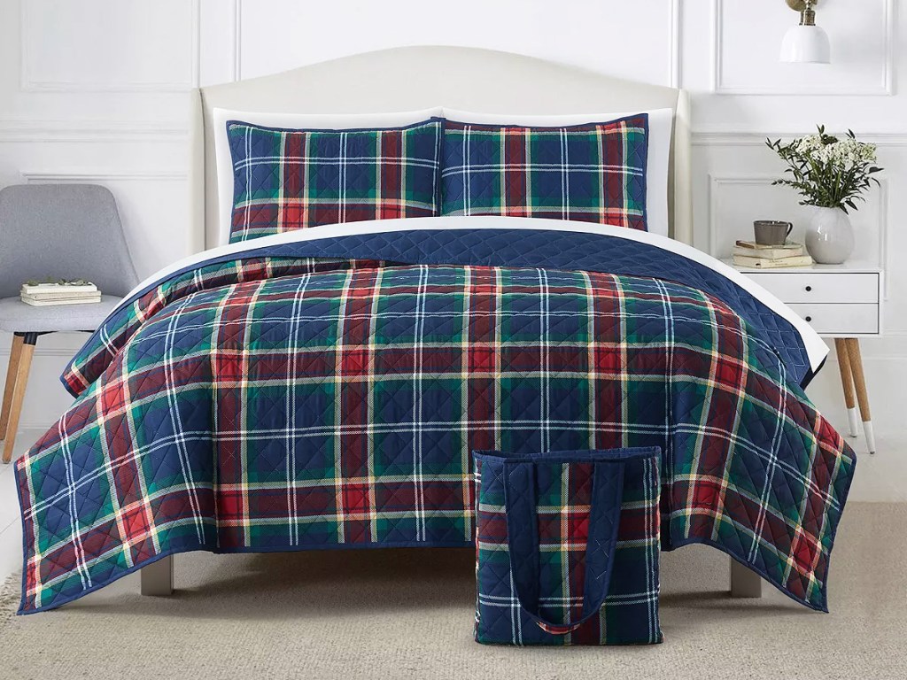 red, blue, and green plaid quilt on bed with matching pillowcases and bag