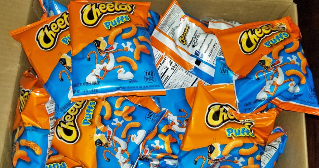 box full of bags of Cheetos Puffs