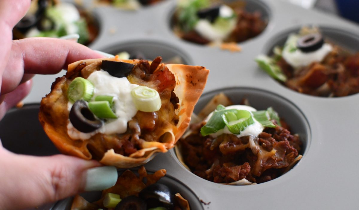hand holding a crispy taco wonton cups, one of our favorite easy GameDay appetizer ideas