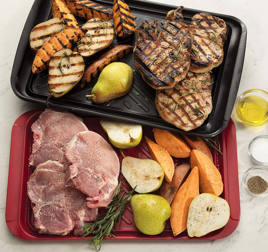grilled and raw foods on black and red trays