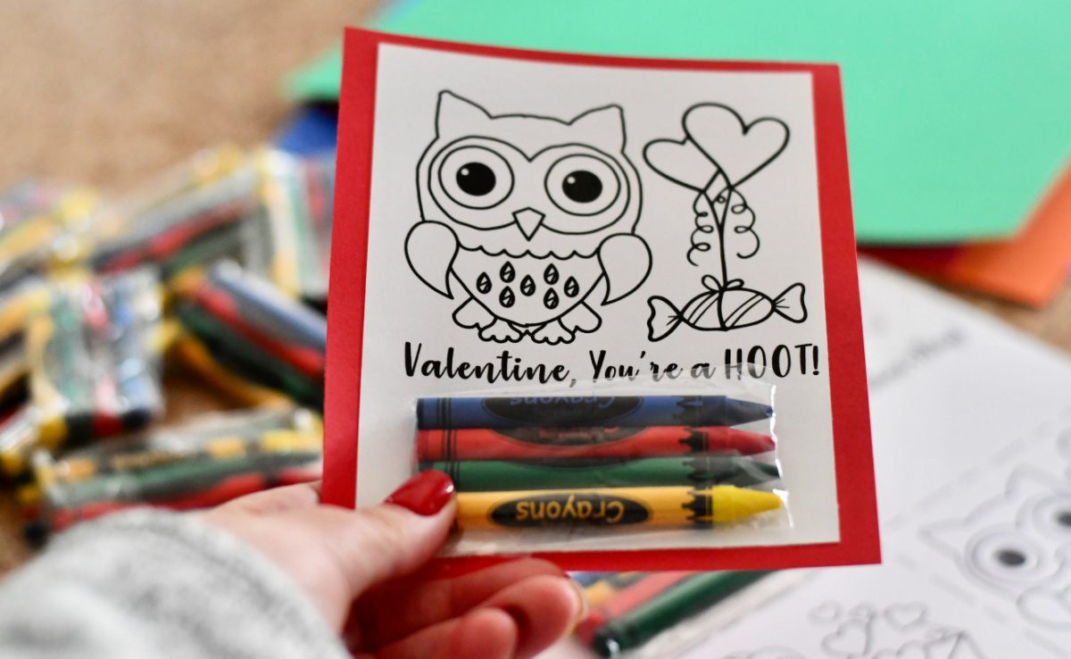 A DIY Valentine's Day card that includes an owl coloring page and a pack of crayons