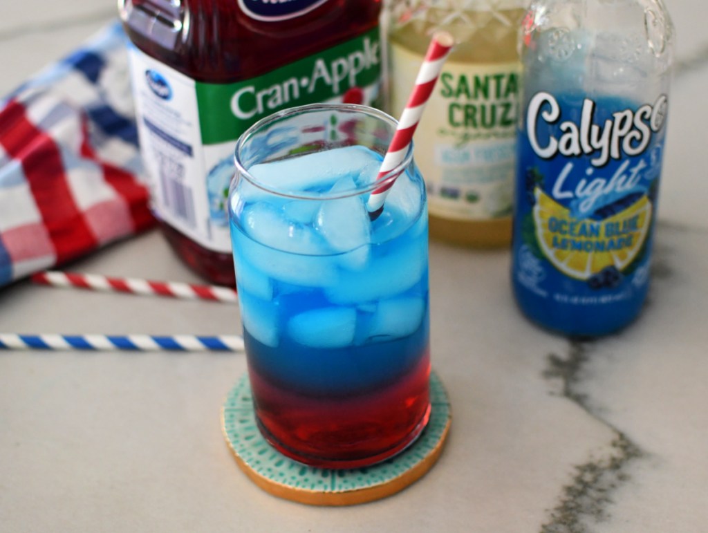A blue and red mocktail with a straw