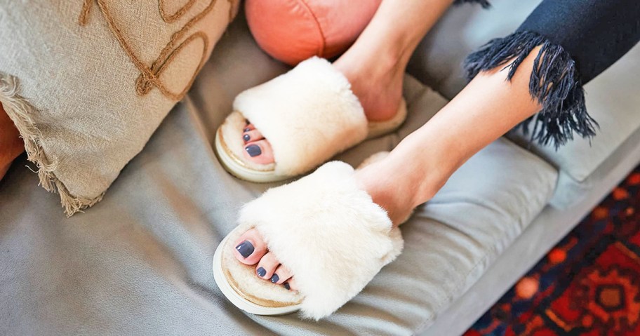 woman on couch wearing white fluffy slipper slides