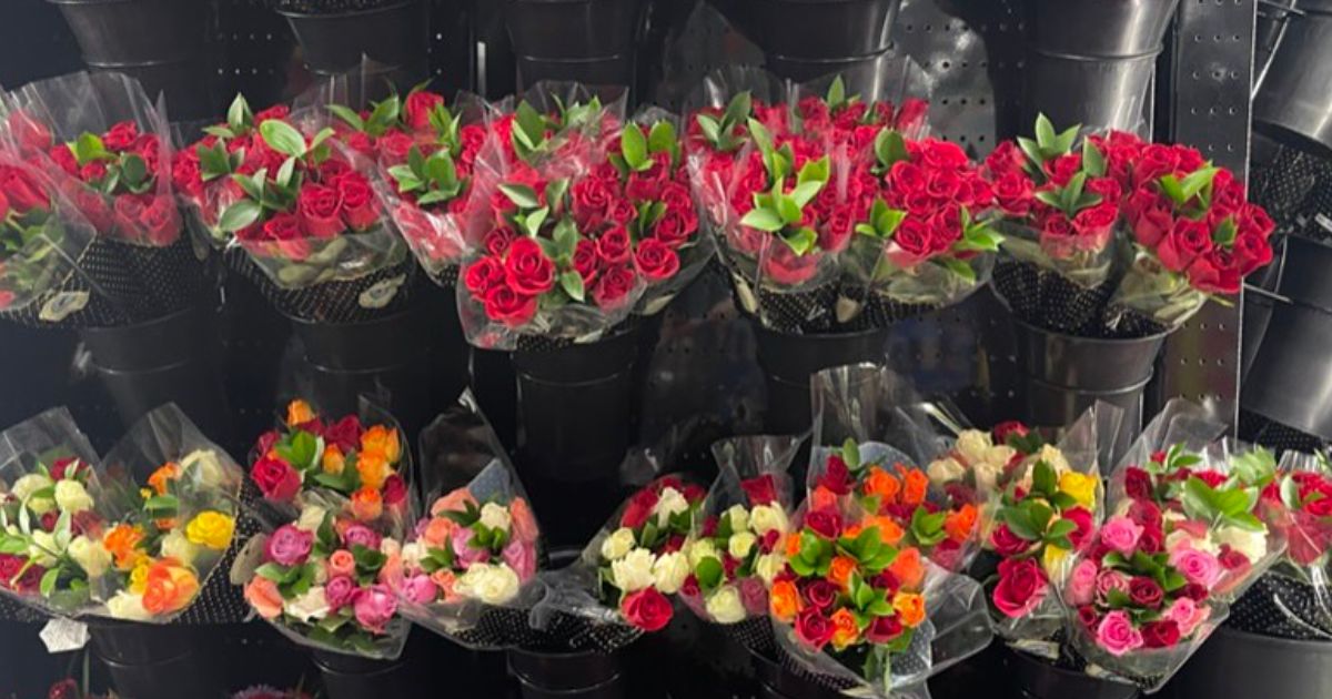 Deluxe floral Bouquets in buckets on a rack in costco