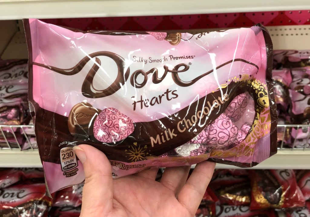 Hand holding a package of Dove hearts, some of the best Valentine's Day Candy to buy