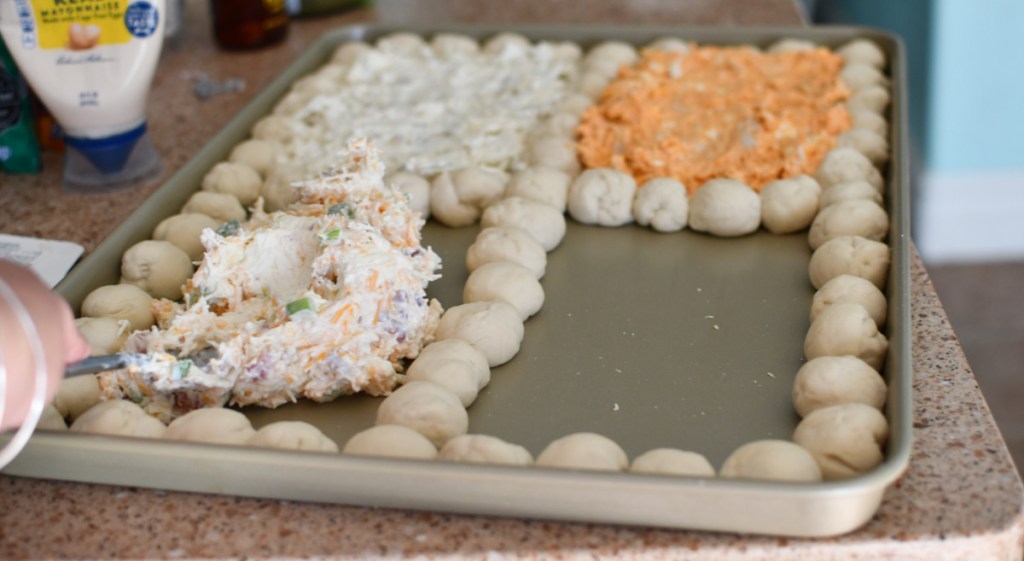Adding cheese dip to a sheet pan party appetizer