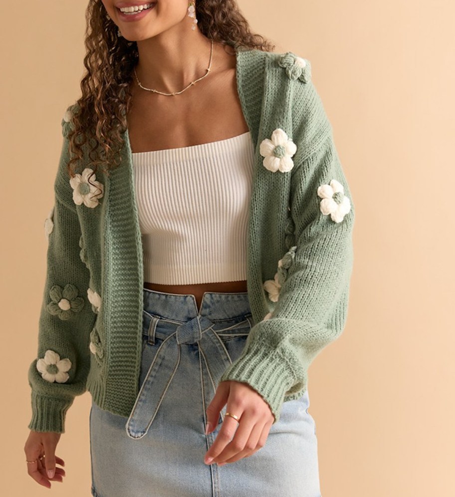 close up of woman wearing 3d flower sweater 