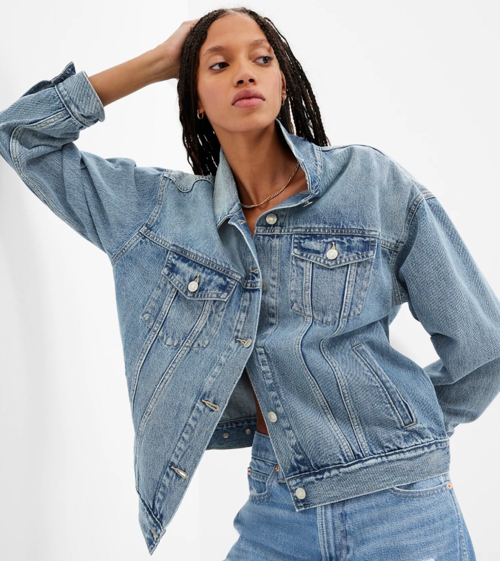 woman posing in denim jean jacket with white background
