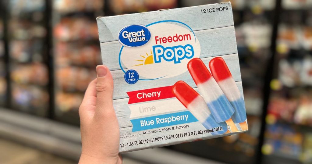 a person's hand hold a box of GV freedom pops in the frozen food section at the grocery 