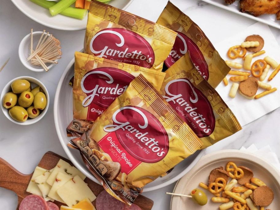 Gardetto's Snack Bags in a bowl on a table surrounded by snacks