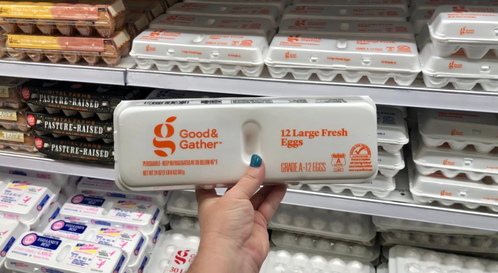 Person holding up carton of good & Gather eggs