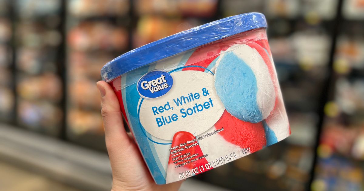 a persons hand holding a carton of Great value red white blue sorbet