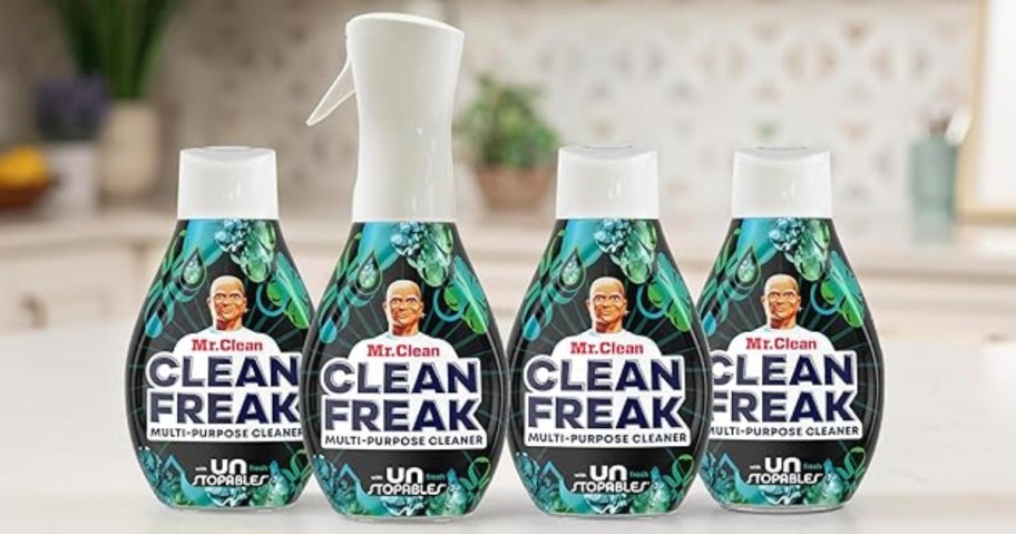 bottle of Mr. Clean Clean Freak cleaning spray with 3 refill bottles on a counter