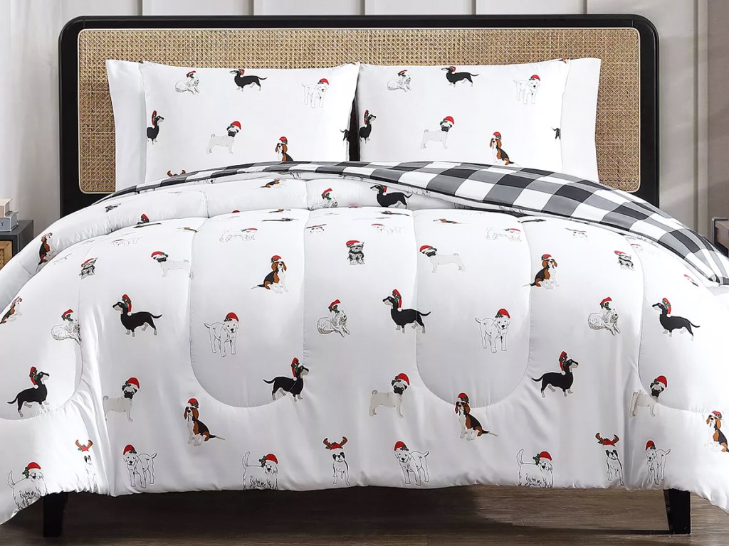 white comforter with dogs wearing santa hats on bed with matching pillow cases