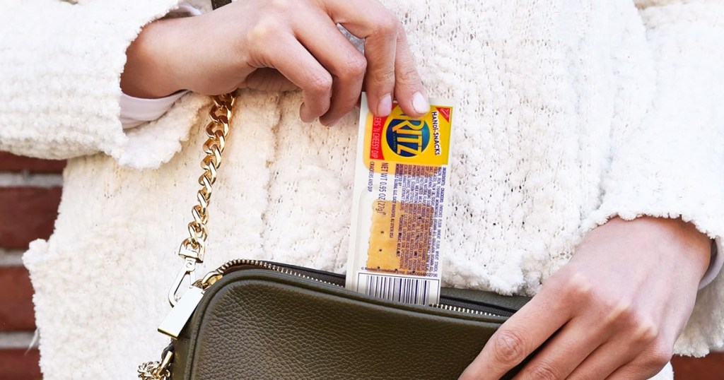 woman pulling a Handi-Snacks RITZ Crackers 'N Cheesy Dip snack pack out of purse