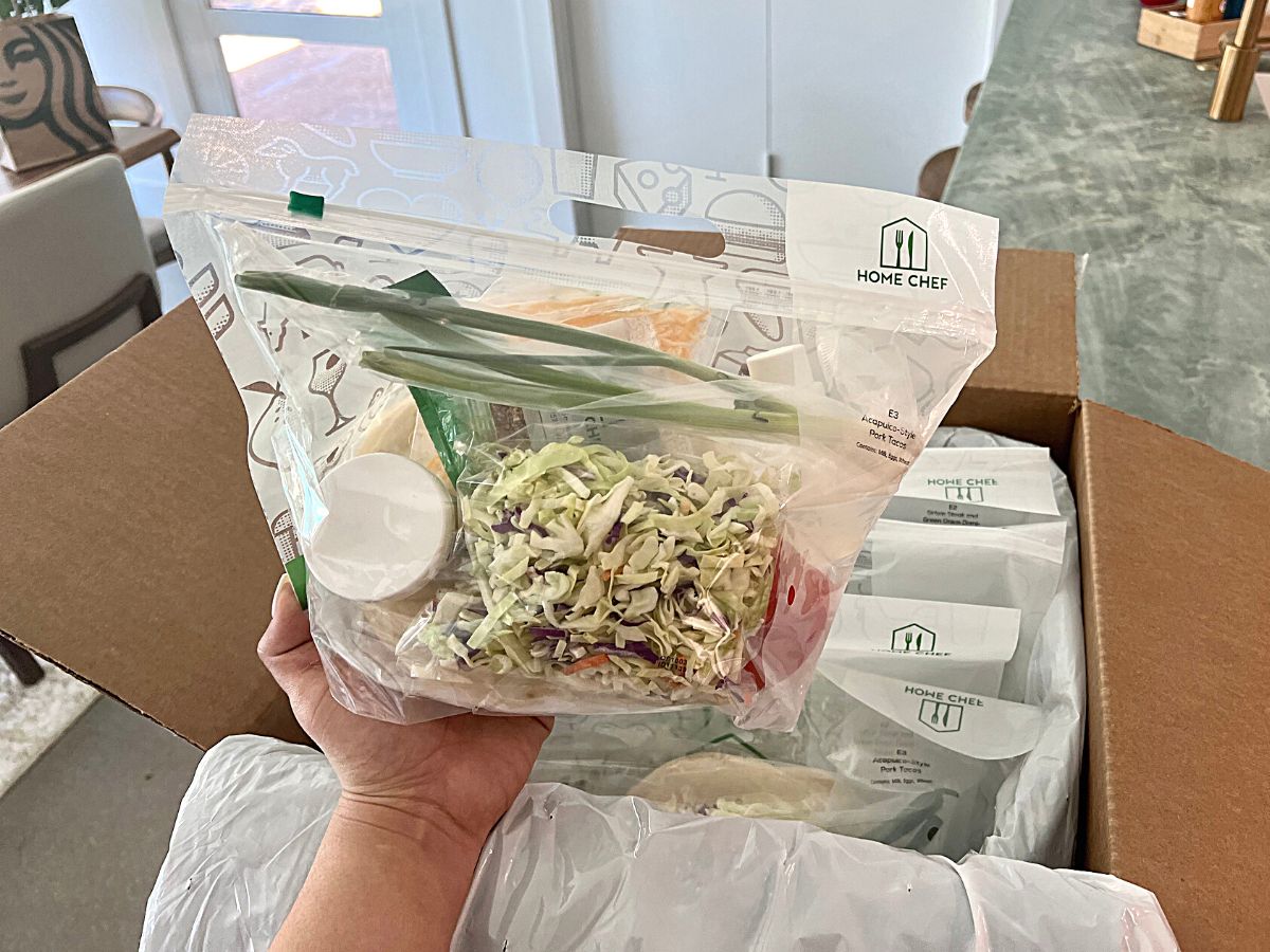 person holding Home Chef bag of ingredients