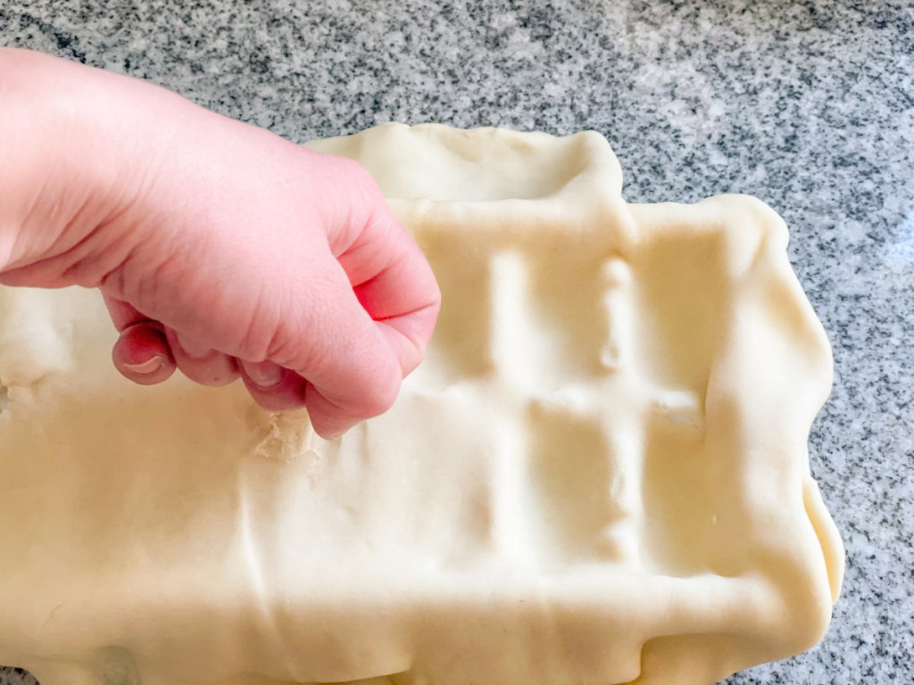 pressing pie dough into an ice cube tray