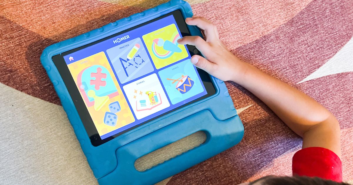 child playing with Homer Learning app on blue tablet