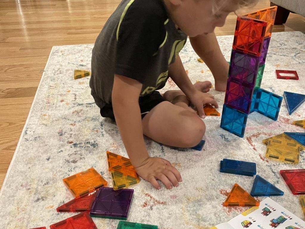 boy playing with magnetic blocks