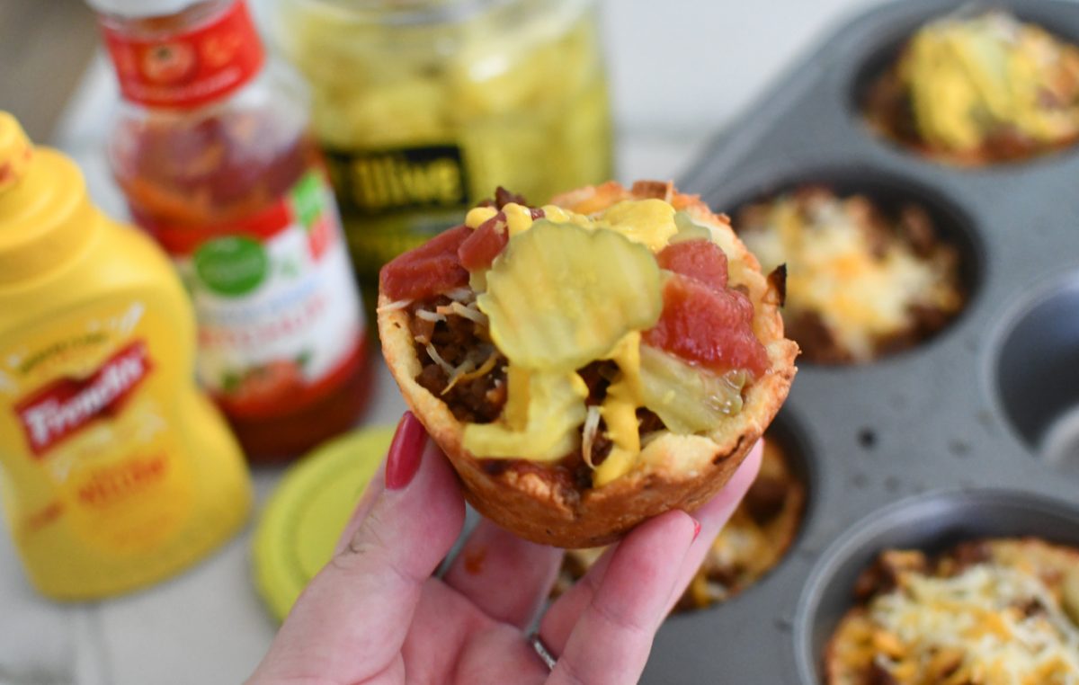 Hand holding up a Keto Cheeseburger Muffin which makes a great GameDay recipe for kids
