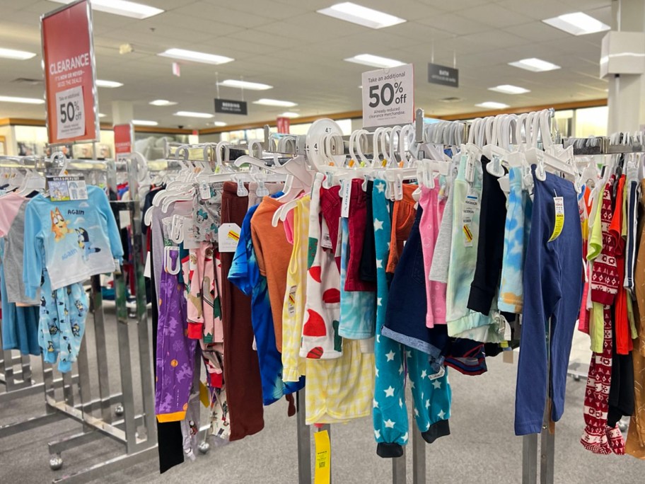 clearance kids clothes hanging on rack in Kohls store