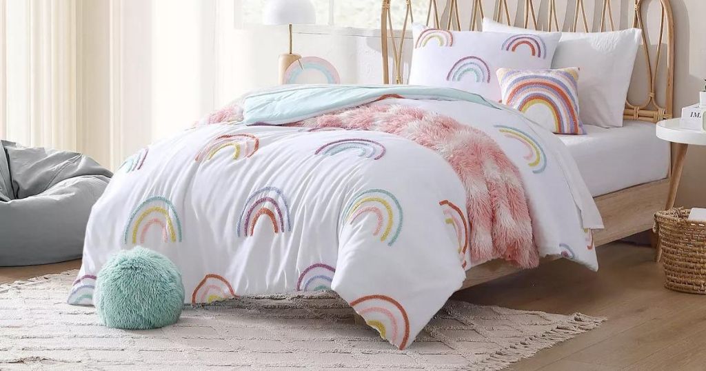 rainbow comforter on bed in bedroom