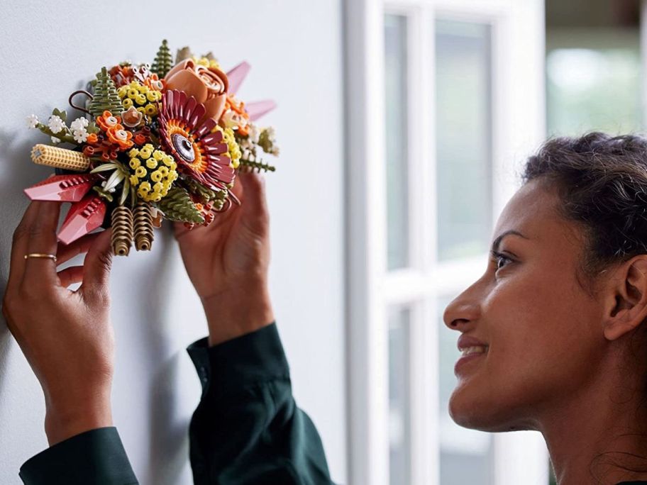 woman holding lego flower centerpiece